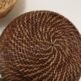 Wall composition of seven baskets and wicker trays.