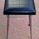Black faux leather and chrome stool. 1970s, vintage seventies decor.