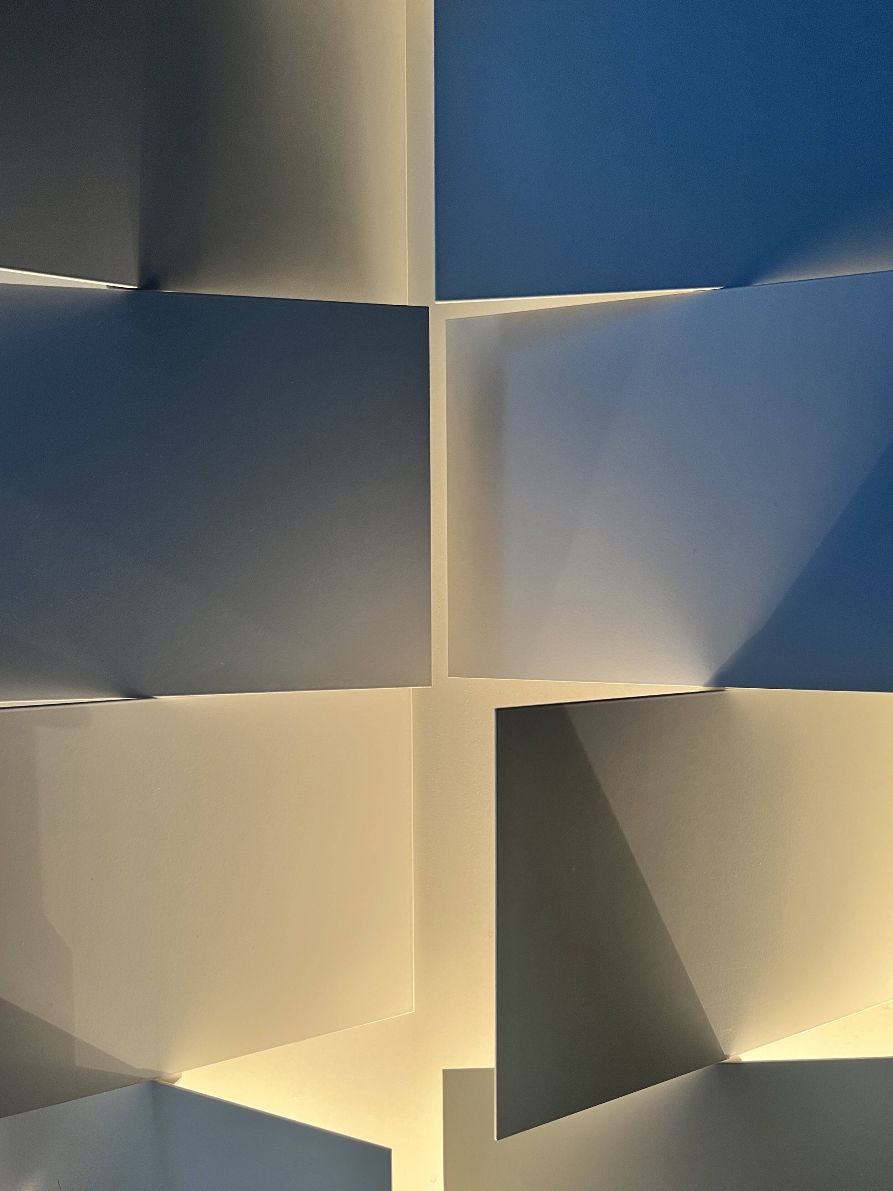 Modernist wall lamp with white metal shade, design by C. Grandidier.