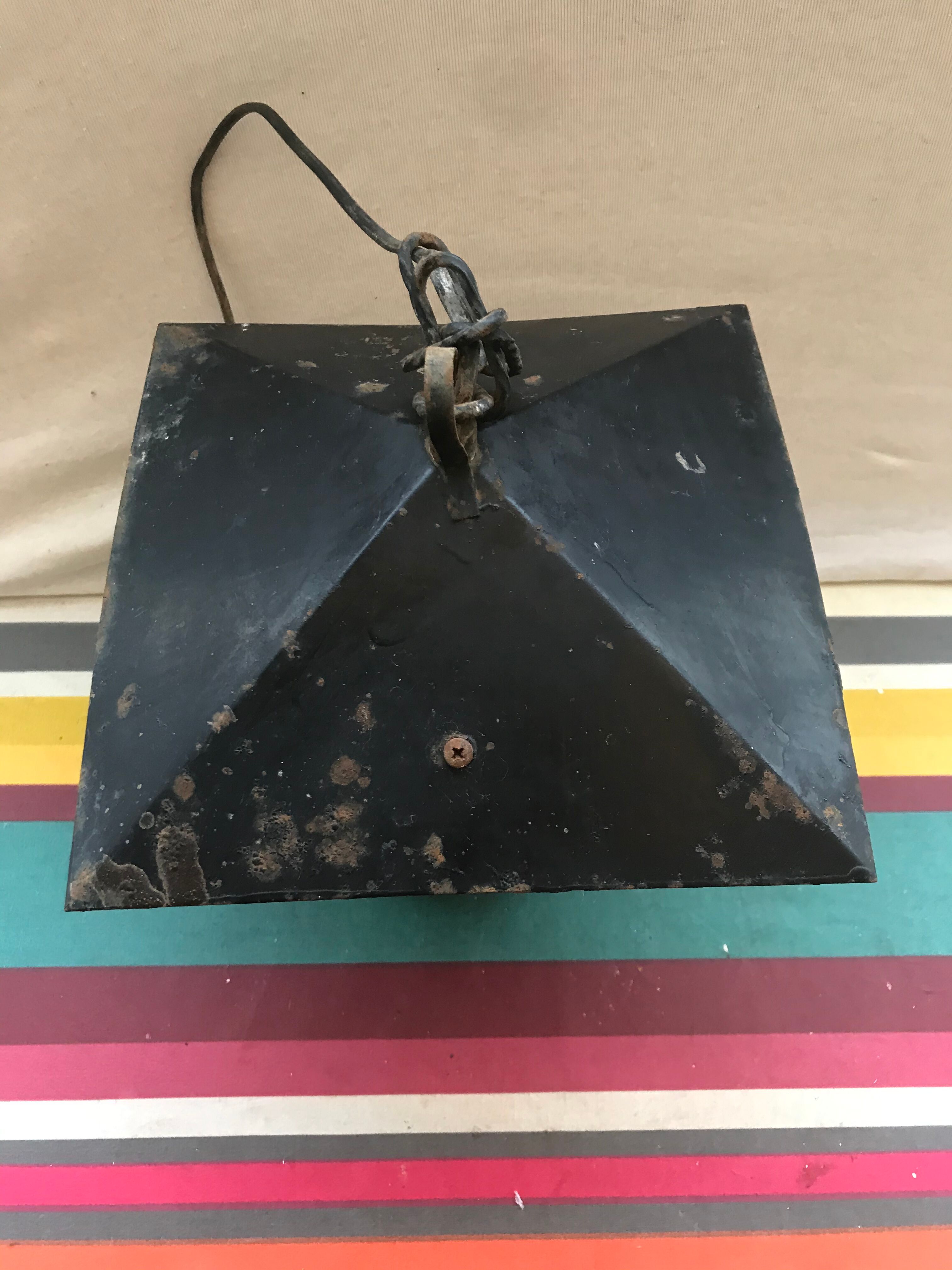 Old black forged iron suspension vintage in moulded glass