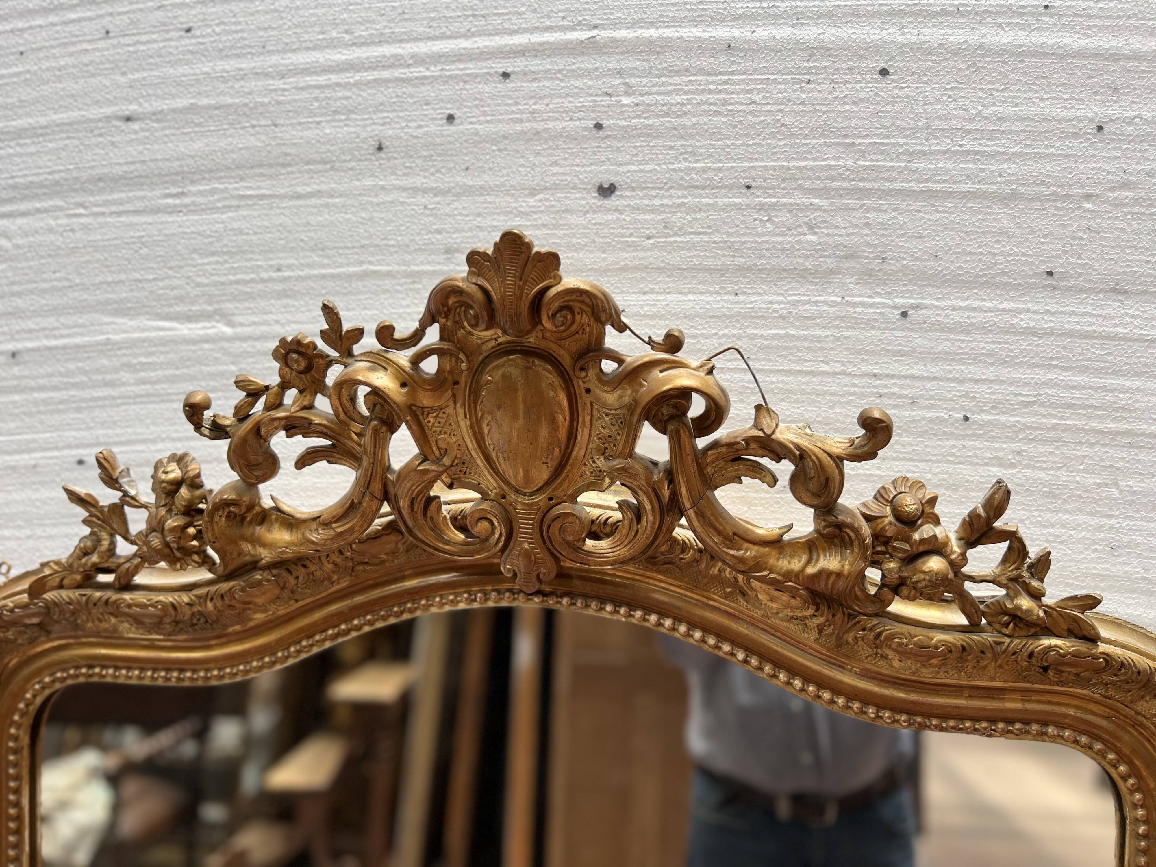 Louis XV style mirror in gilded wood and stucco, 20th century.