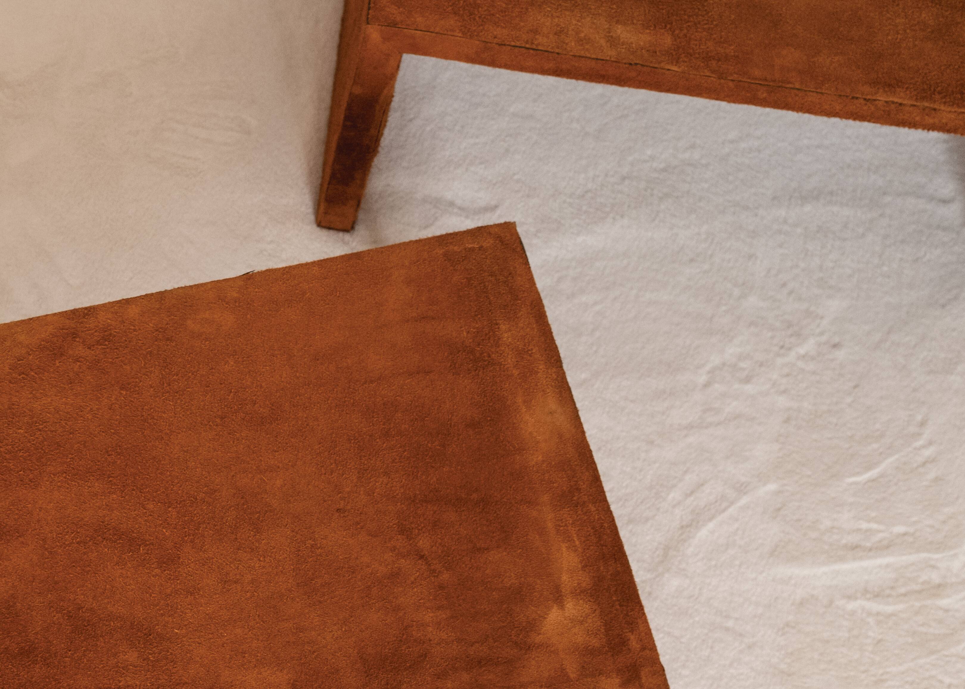 Pair of cognac suede side tables in the style of Jean Michel Frank.