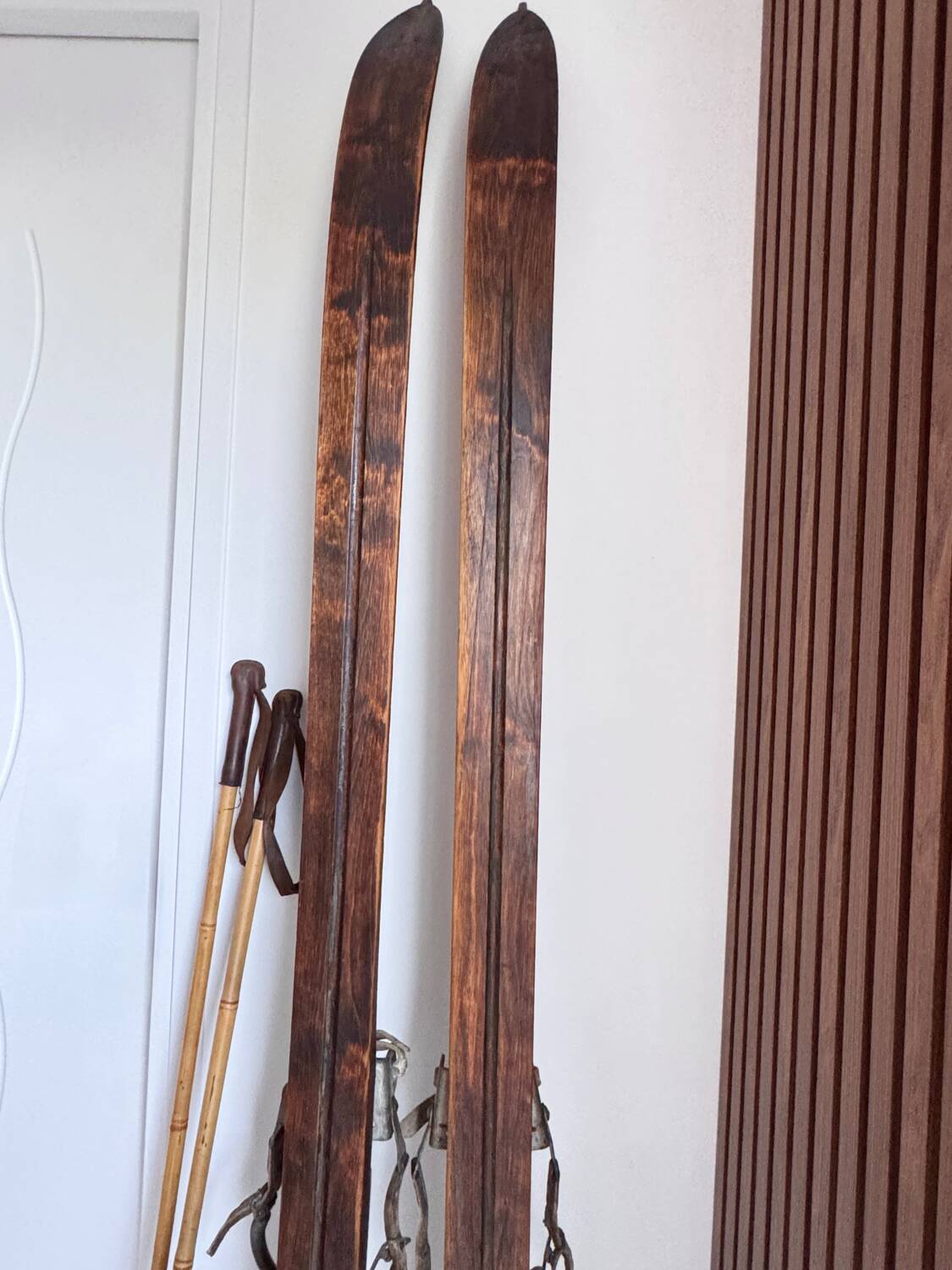Antique wooden skis with vintage poles