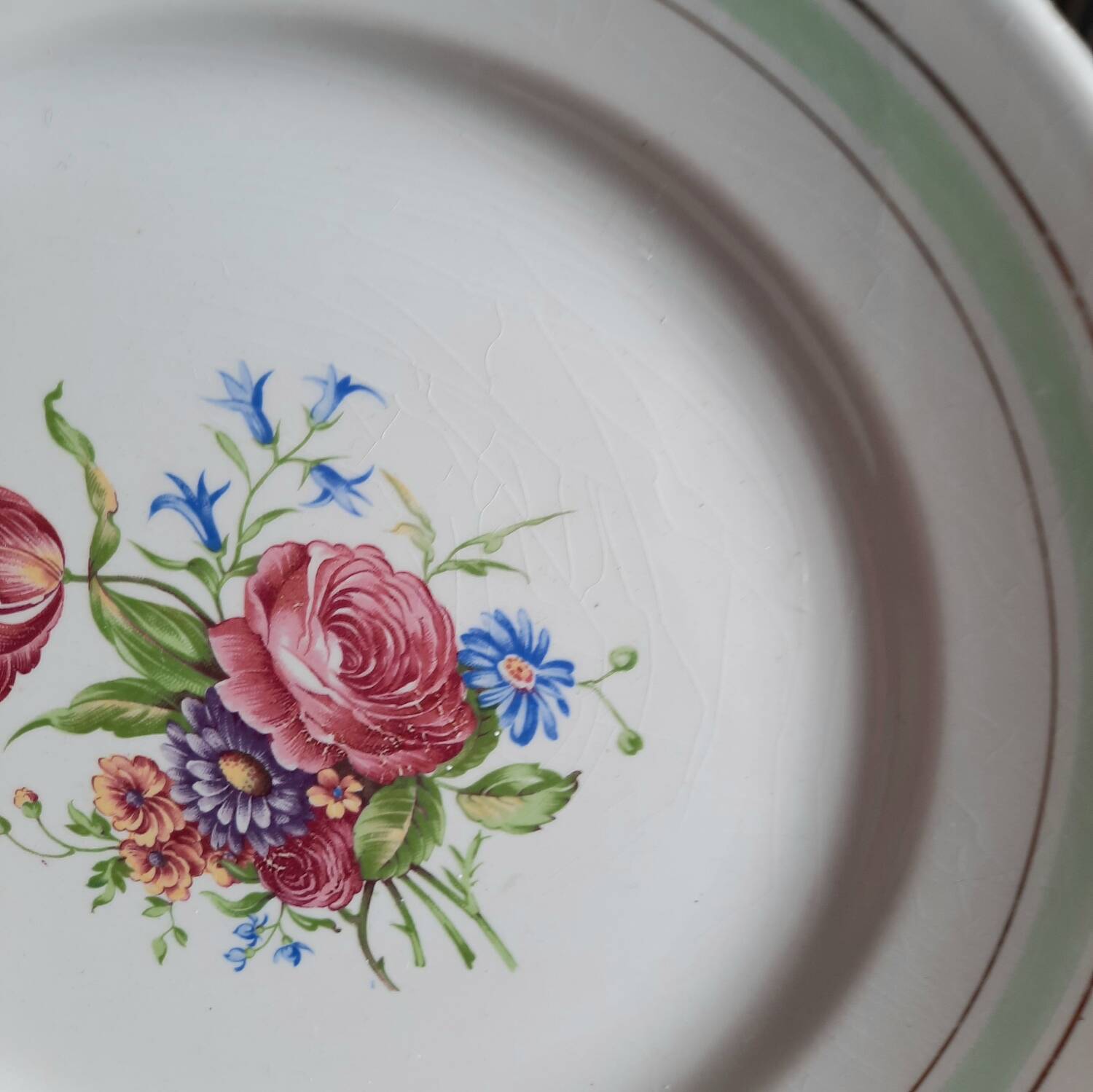 Old mismatched earthenware dinner plates accompanied by a deep dish