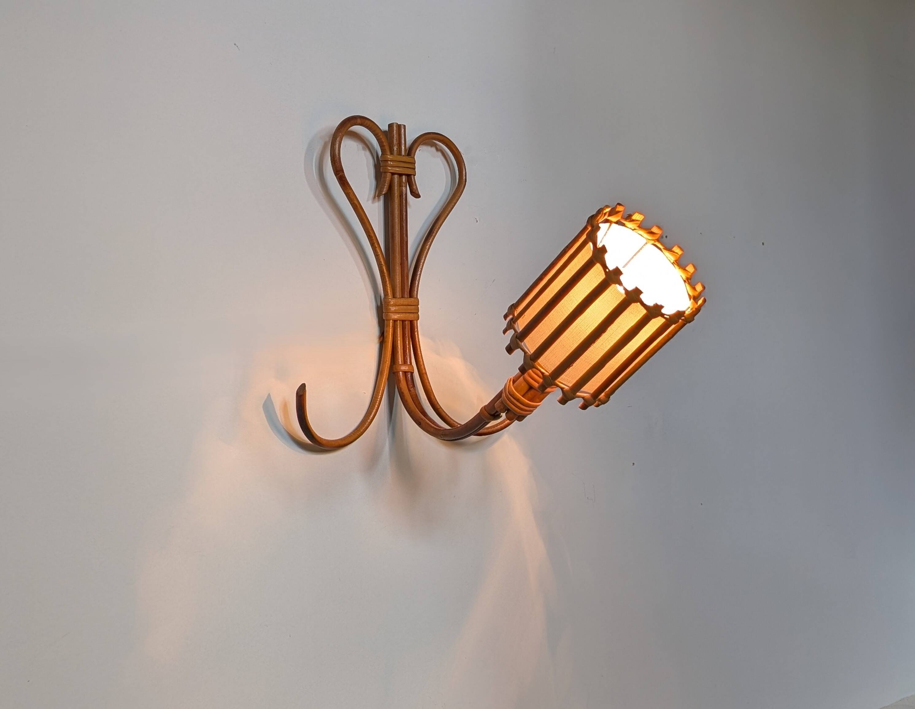 Rattan wall lights by Louis Sognot