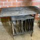 Antique writing desk, blackened wooden filing cabinet.