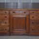 Antique Victorian oak kneehole desk with 18 double-sided drawers.