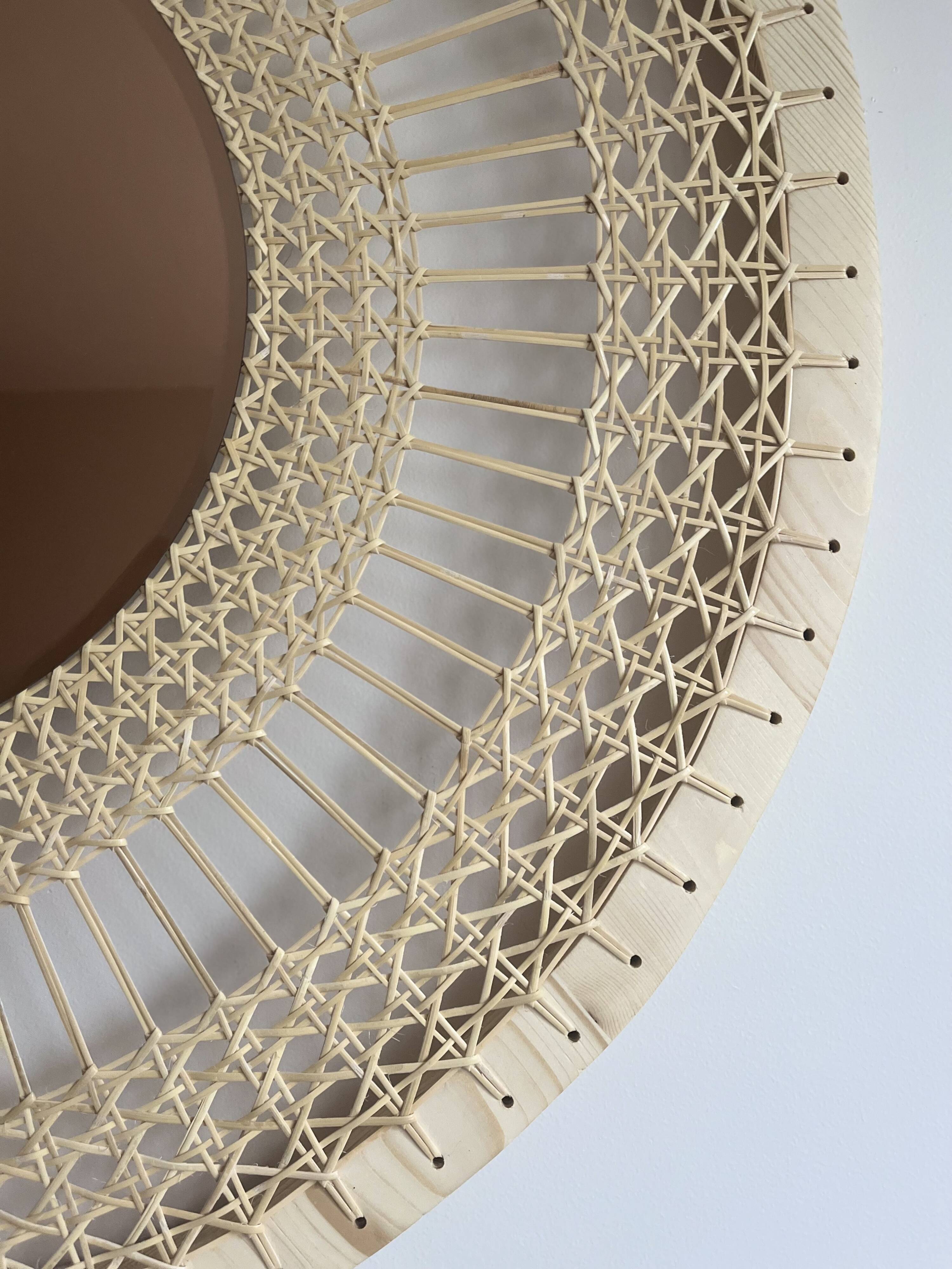 Decorative mirror in woven sun cane