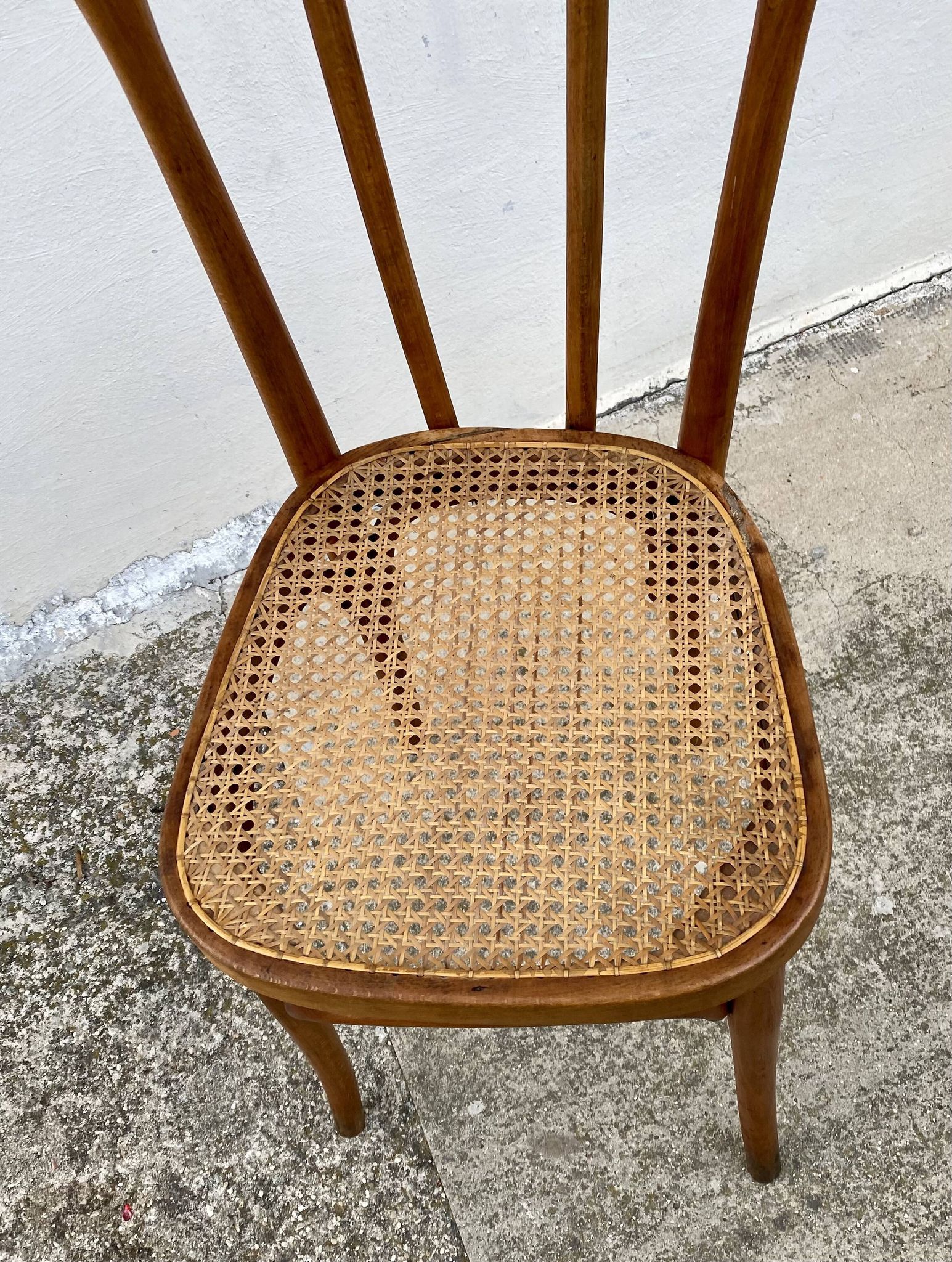 19th-century bistro chair, signed, with caned seat.