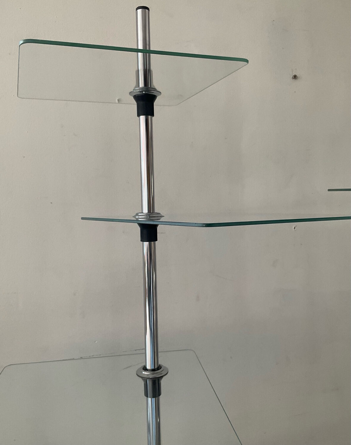 A pair of vintage side tables in glass and chrome metal.