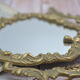 Adjustable psyche mirror of 33 centimeters in gilded bronze with angel ornament