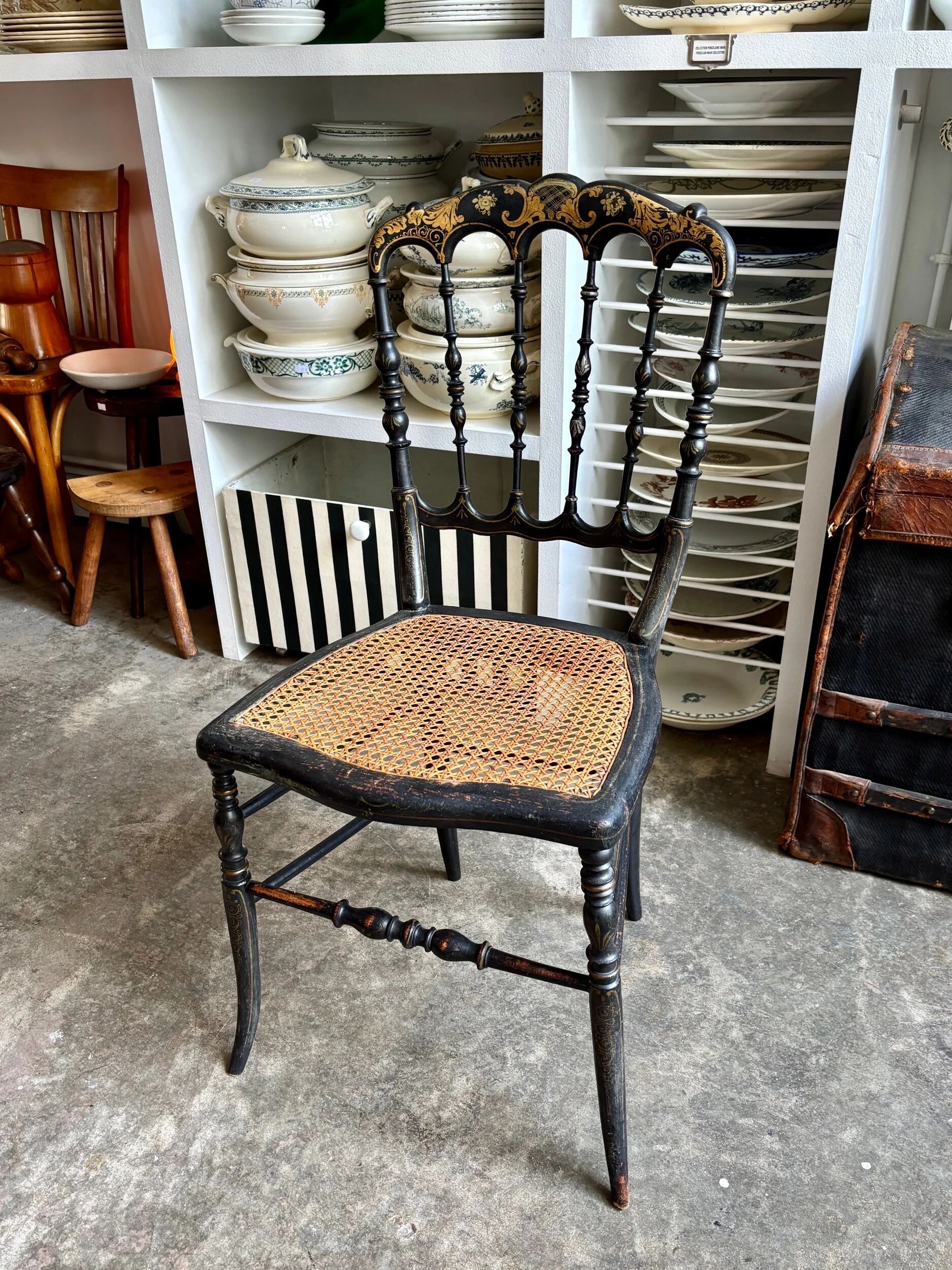 Napoleon III chair in black and gold wood with caning.