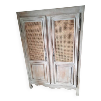 Small painted cupboard with cane doors.