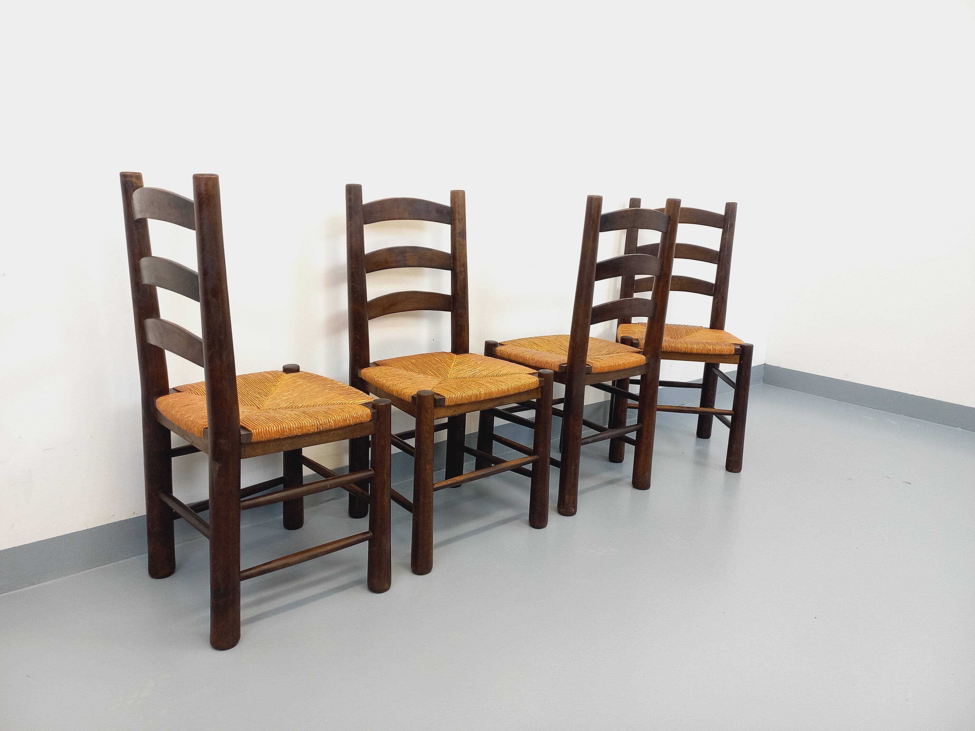 Set of 4 vintage brutalist chairs by Georges Robert in wood and straw.