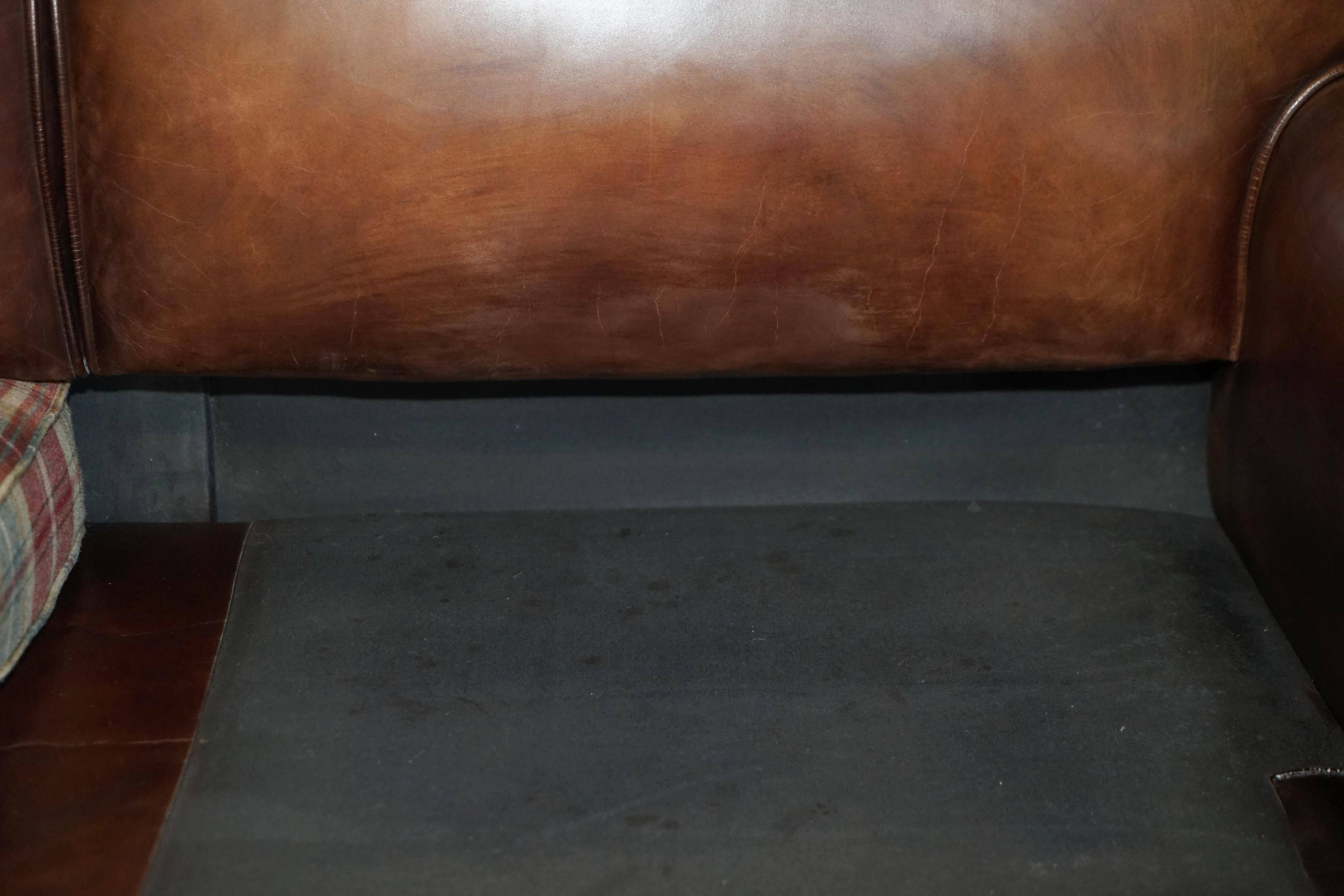 George Smith Signature Scroll leather canapé with tartan Scottish wool cushions.