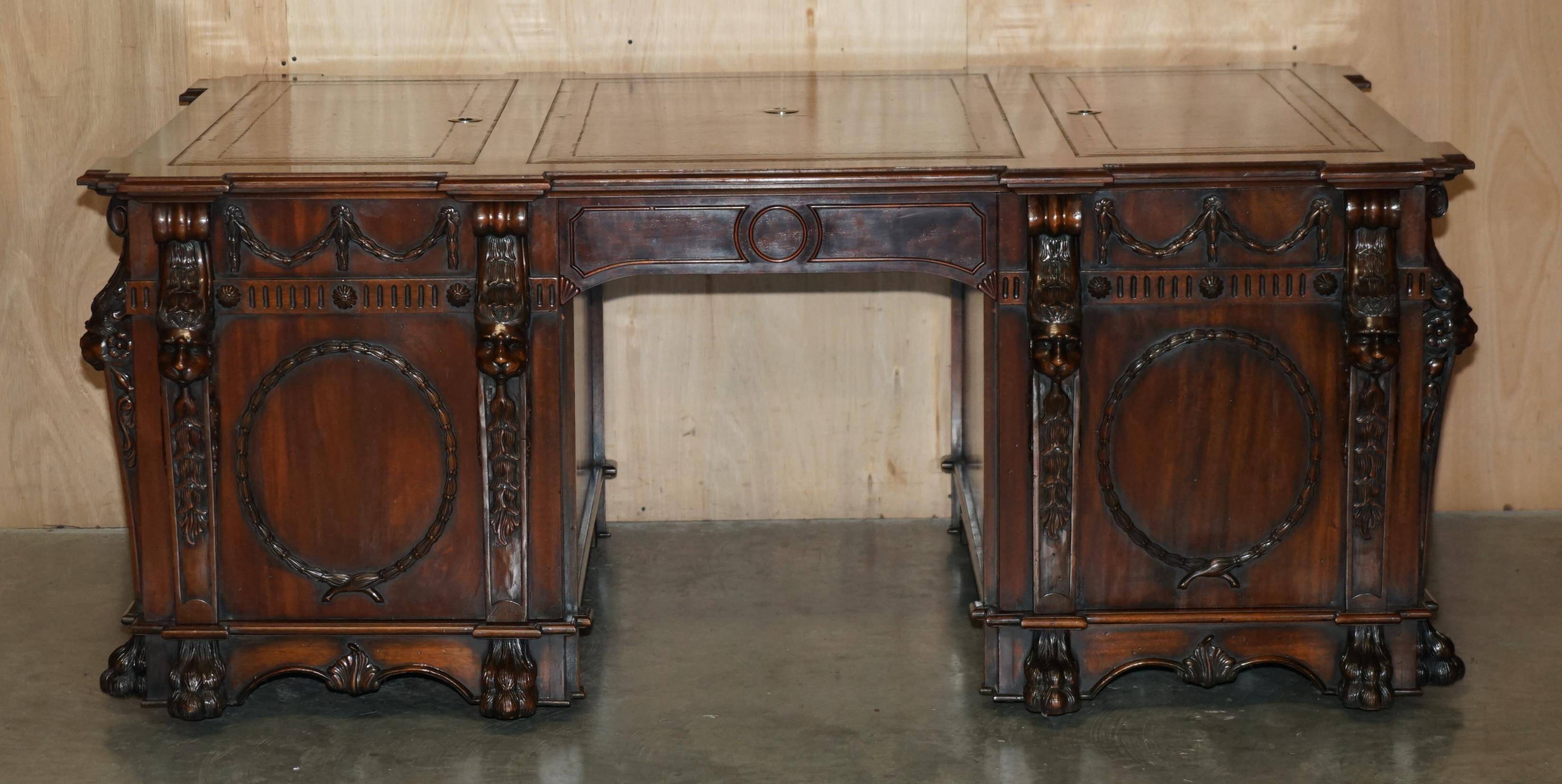 Partner desk with two carved columns featuring lion heads, according to Thomas Chippendale, restored.