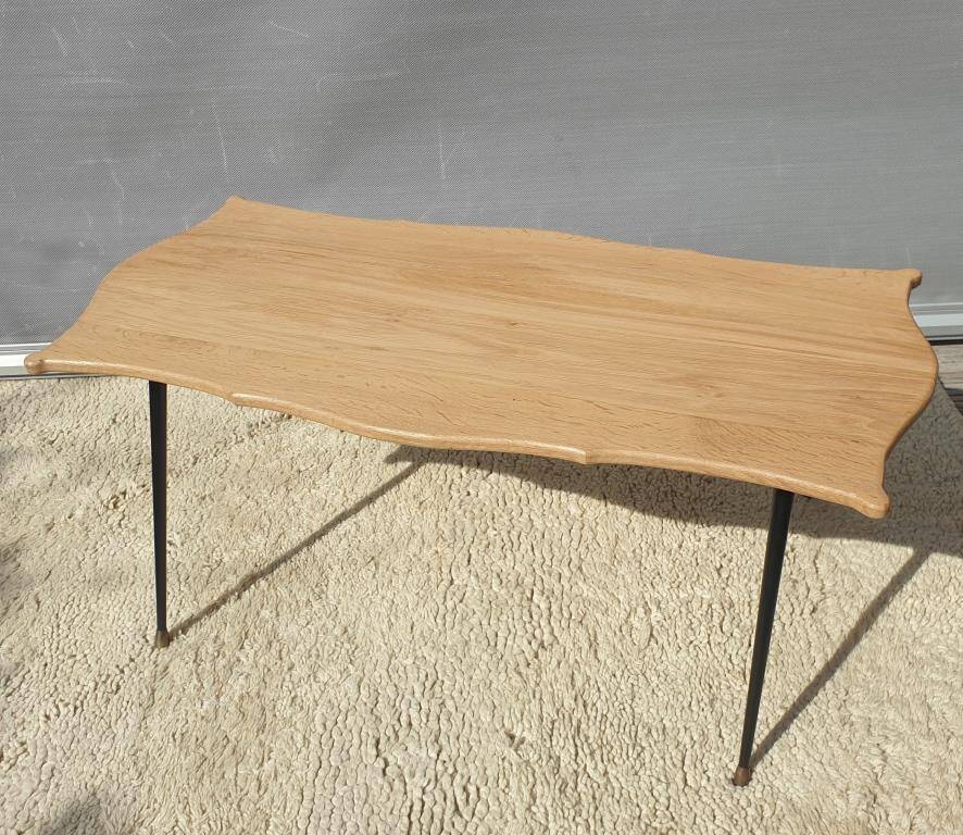 Violin-shaped coffee table with brass legs