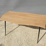 Violin-shaped coffee table with brass legs