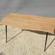 Violin-shaped coffee table with brass legs
