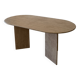 Oblong dining table in beige travertine.