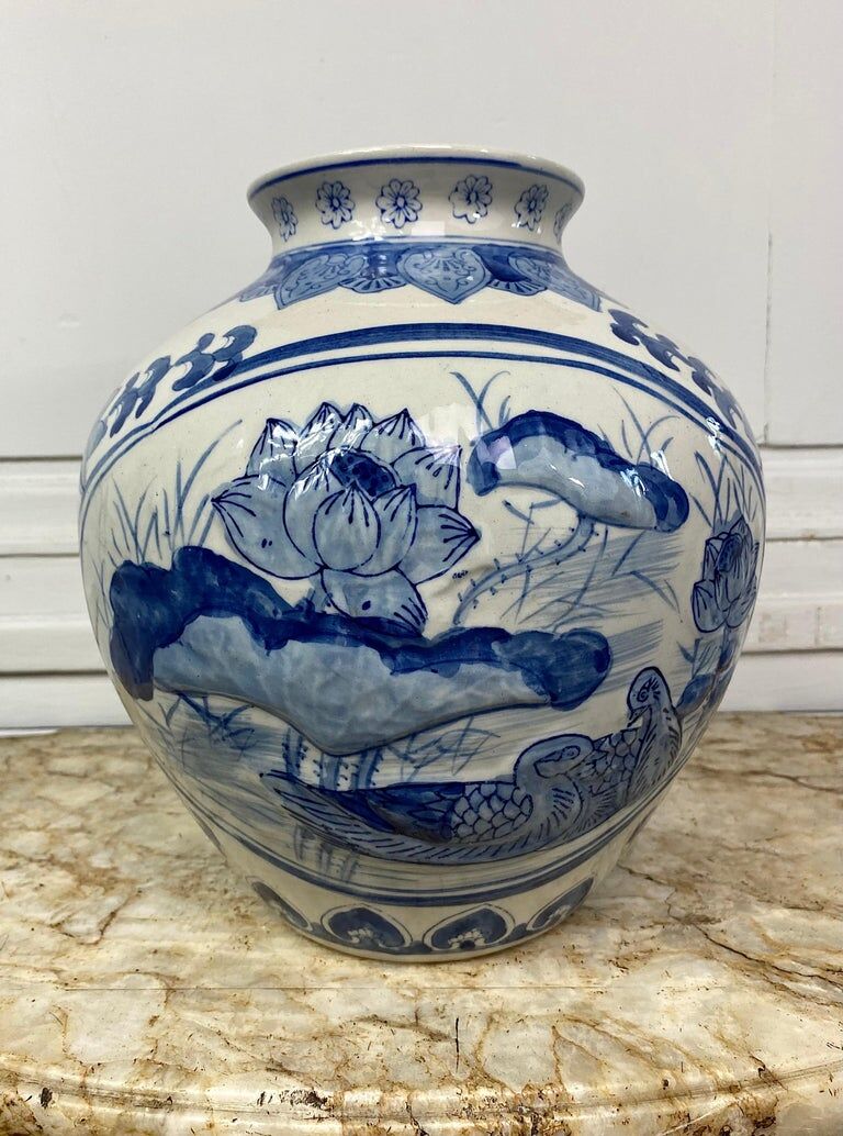 Chinese vase in blue-white porcelain decorated with lotus flowers