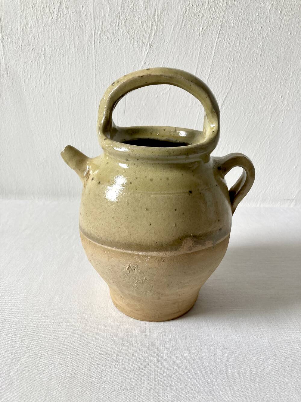 Old small goat-shaped jug in ochre glazed stoneware.