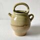 Old small goat-shaped jug in ochre glazed stoneware.