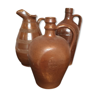 Lot of three bottles or pitchers in glazed sandstone