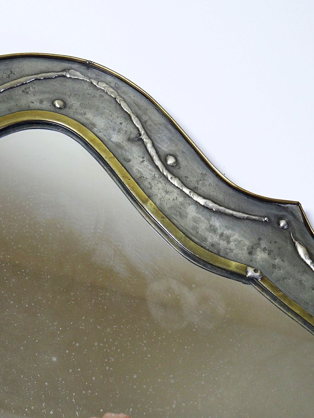 Brutalist mirror by Jean Goardère, brass and tin, 1970s.