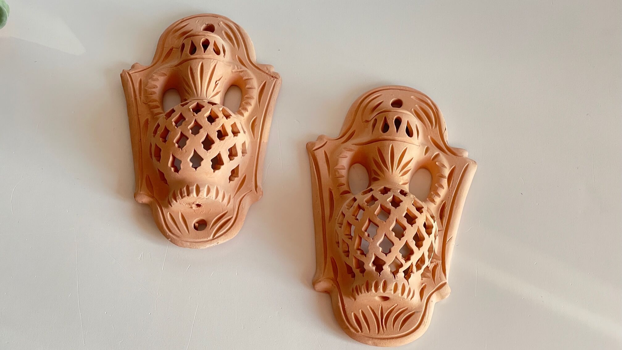 Pair of terracotta wall candle holders