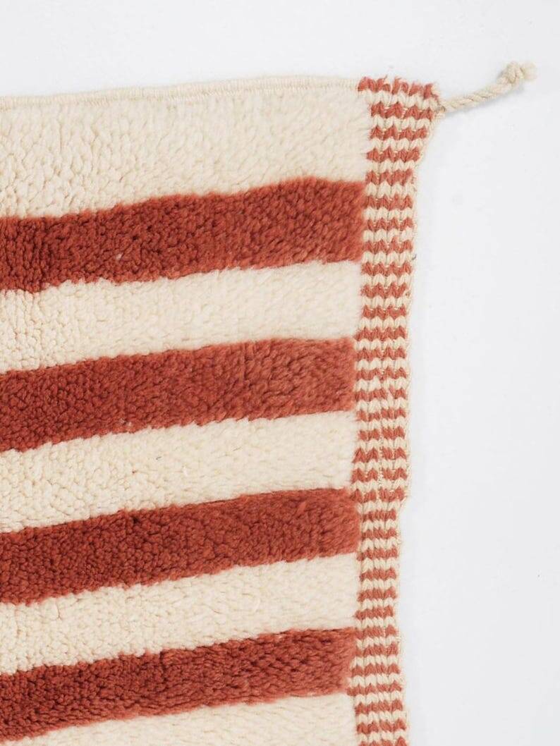 A handmade Moroccan striped terracotta rug, 150/250cm