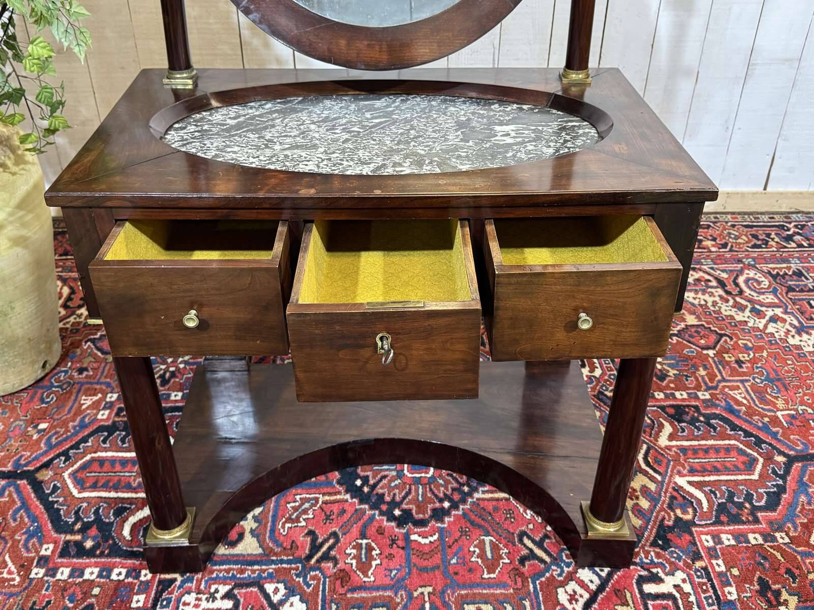 Empire hairdresser from the 19th century in mahogany with a marble top.