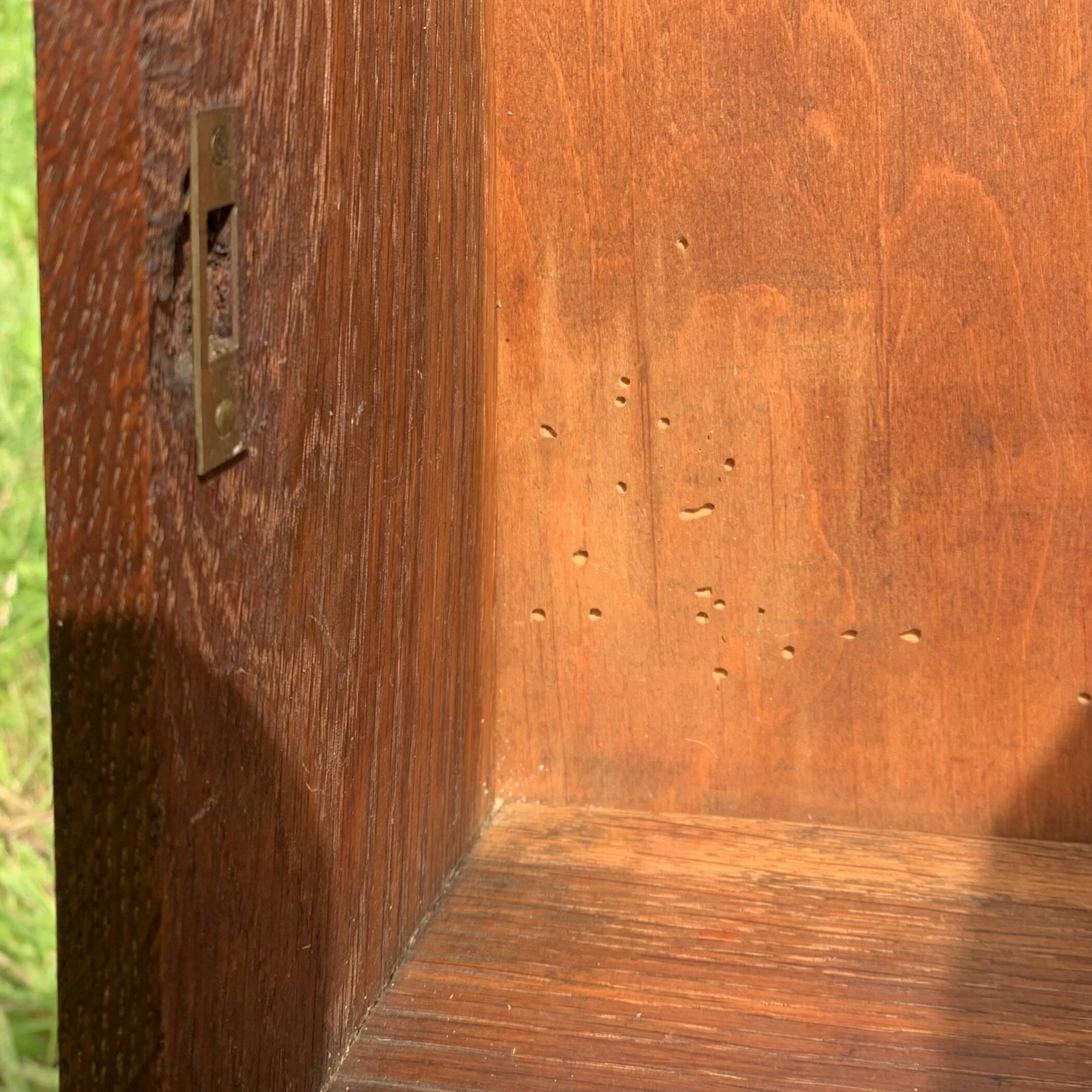 Old carved wooden medicine cabinet with beveled mirror