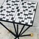 Wrought iron stela and black and white tiled top from the 1960s.