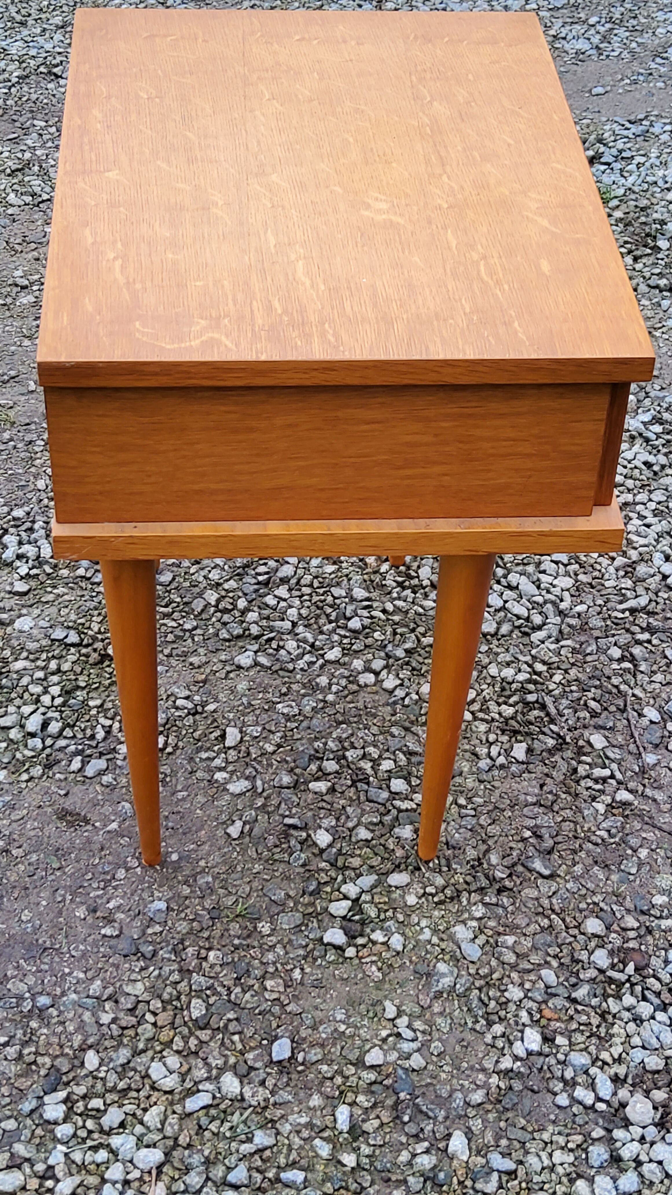 Vintage bedside table in golden blond oak conical feet from the 60s