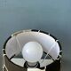 Small Space Age table lamp with a porcelain base and black and white flower shade.