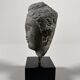 Sculpture of a Buddha head in grey schist from Gandhara, ancient Greece.