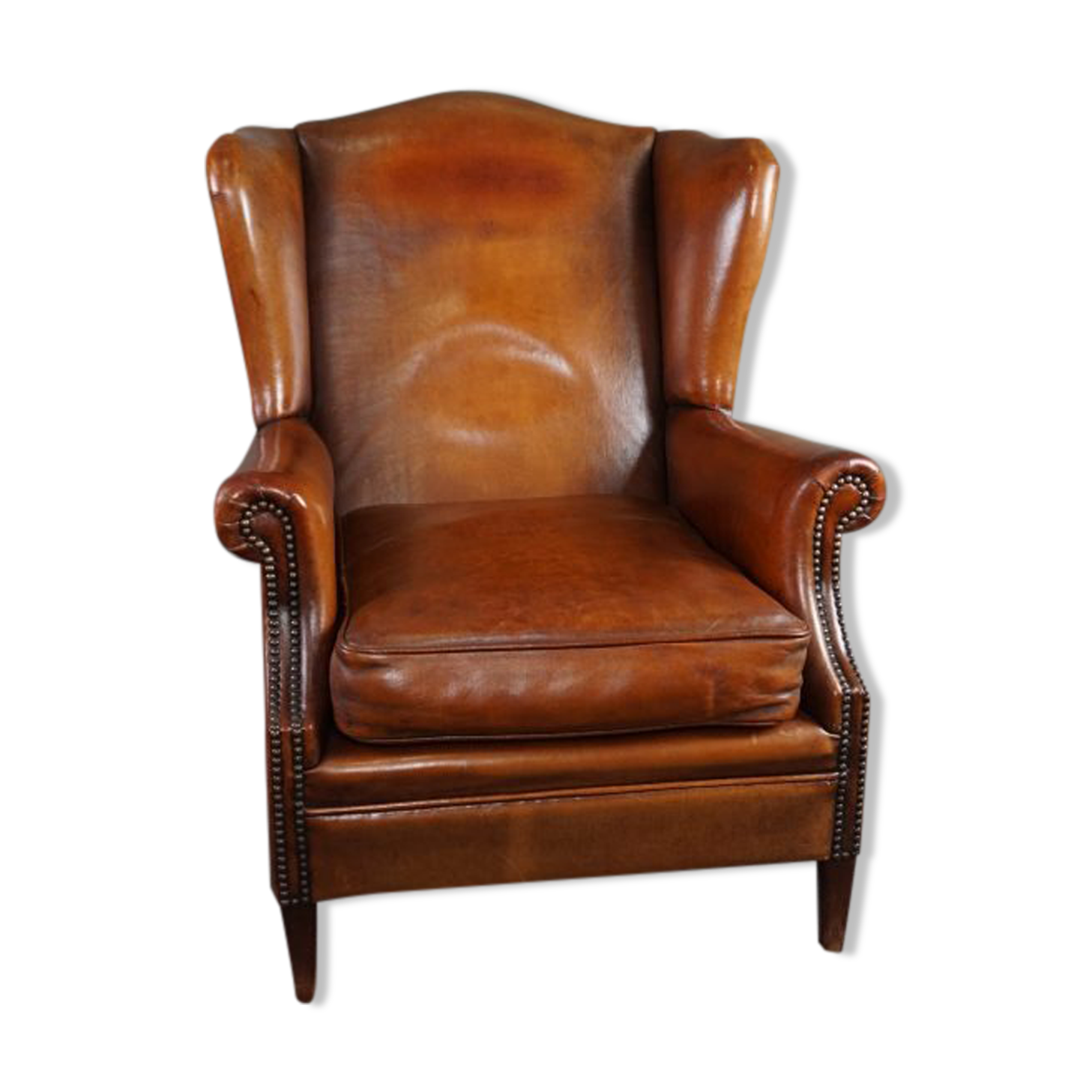 Eared armchair in patinated sheepskin
