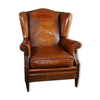 Eared armchair in patinated sheepskin