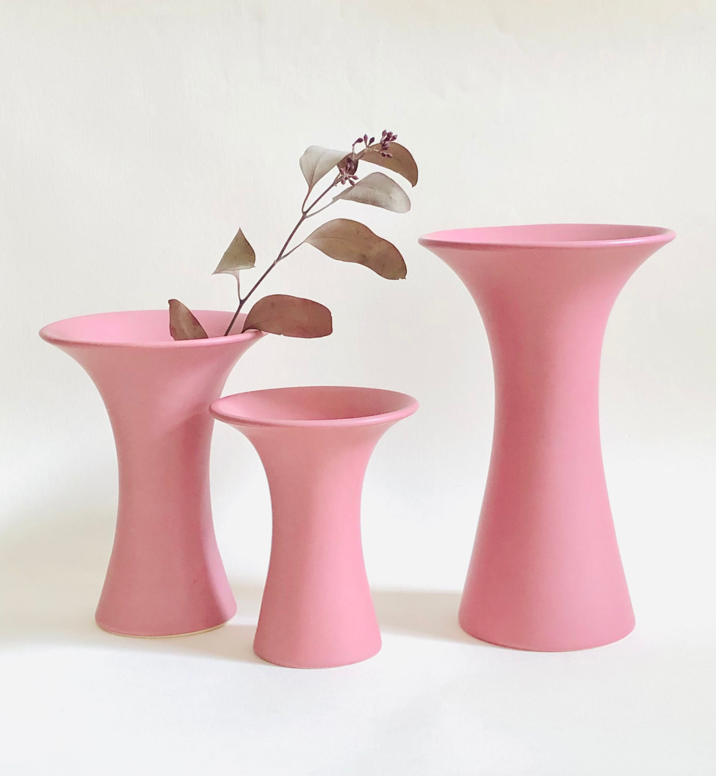 Set of three matte pink ceramic vases