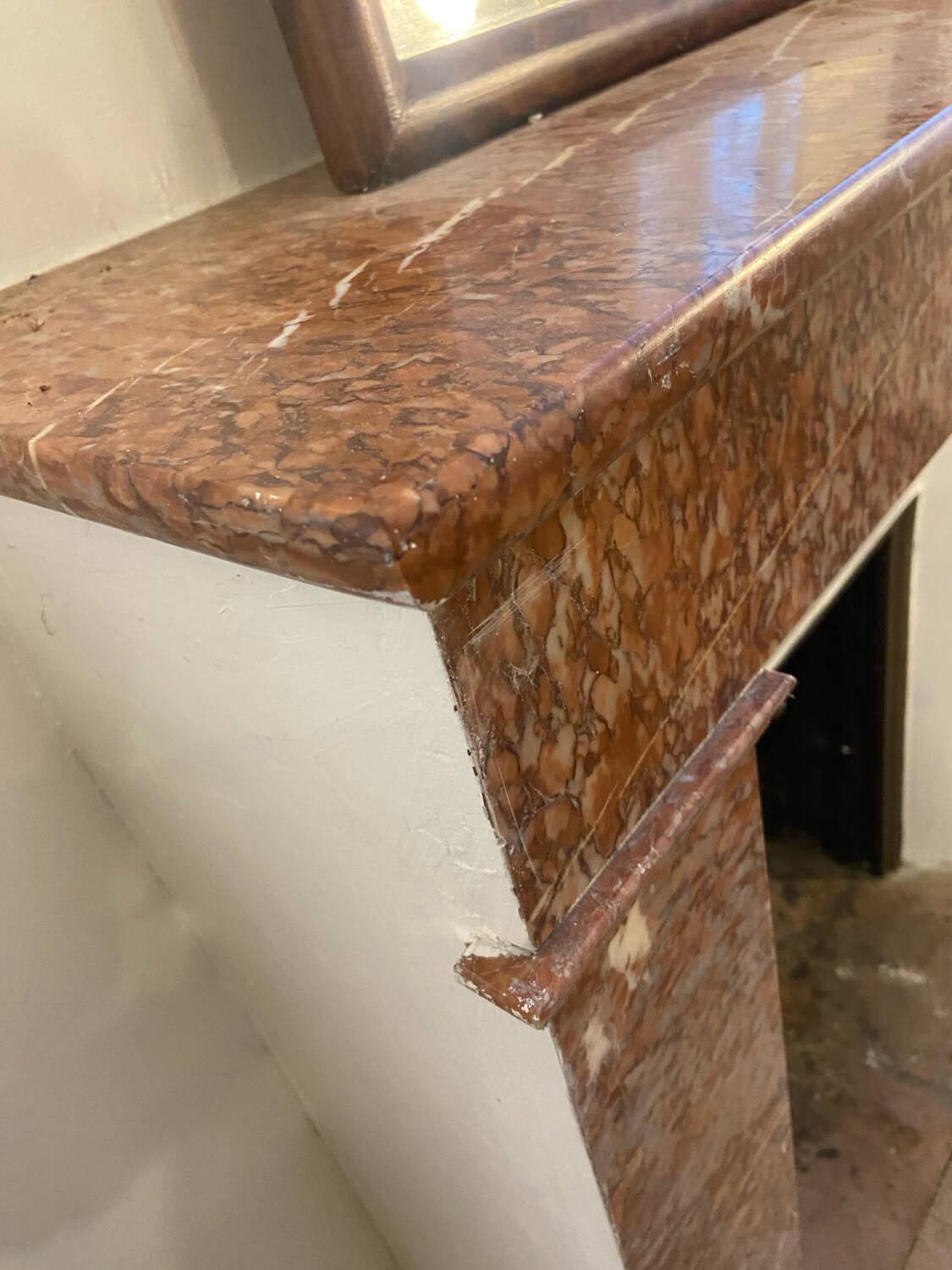 Marble fireplace surround with closed hearth frame.