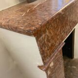 Marble fireplace surround with closed hearth frame.