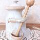 Old large vintage stoneware olive pot with its wooden spoon