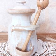 Old large vintage stoneware olive pot with its wooden spoon