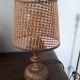 A very original vintage lamp with its cane lampshade