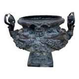 Cast iron vase decorated with mermaids.