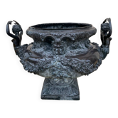 Cast iron vase decorated with mermaids.