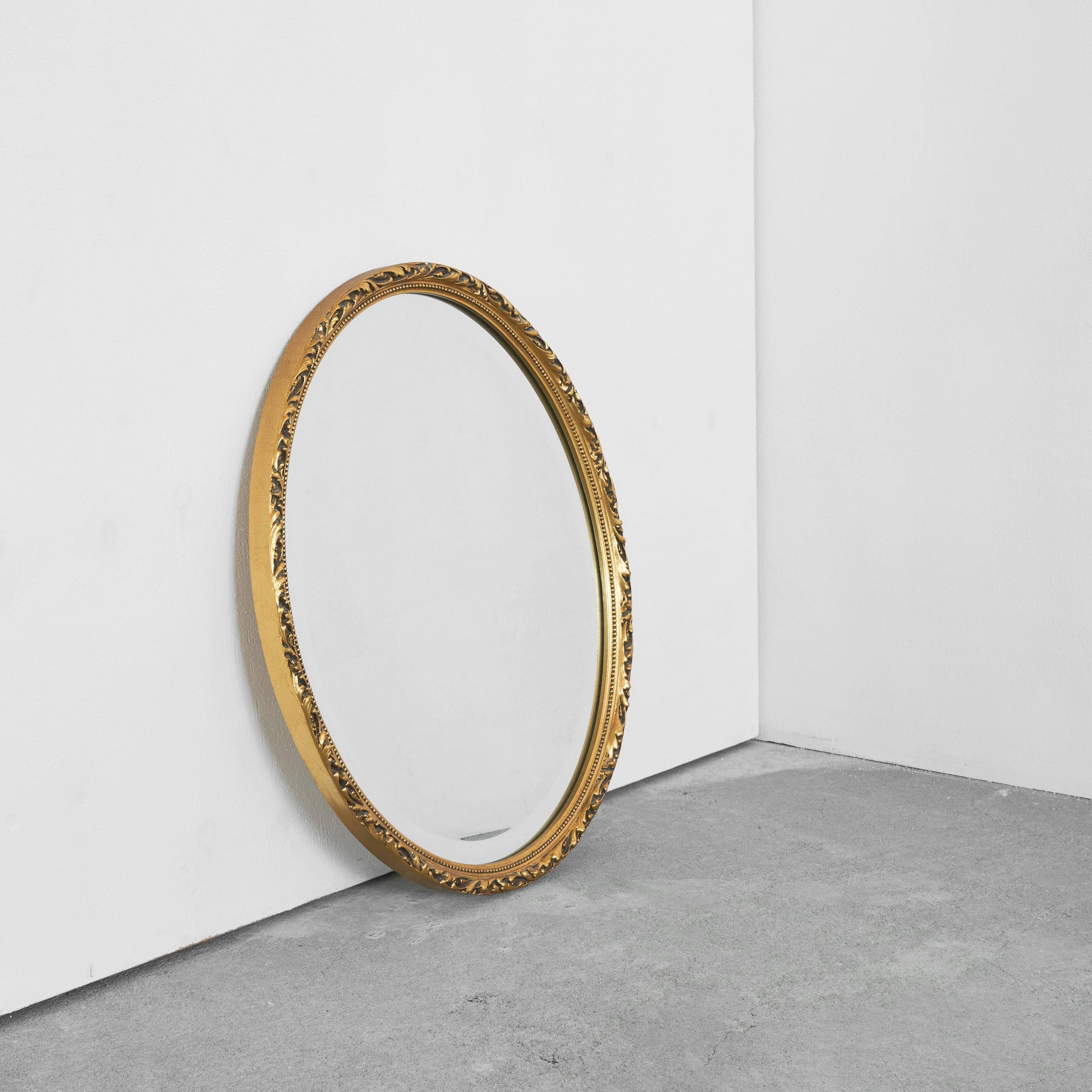 Oval mirror with gilded wood from the 1960s.