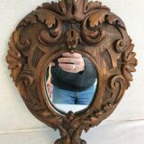 Ancient mirror in carved wood, vintage decoration