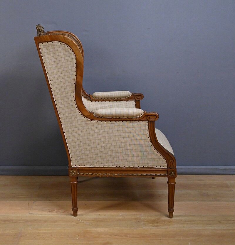 Wingback armchair in walnut, Louis XVI style – late 19th century